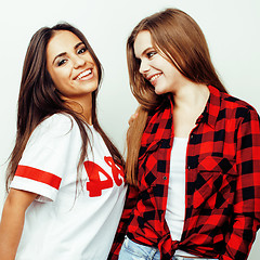 Image showing best friends teenage girls together having fun, posing emotional on white background, besties happy smiling, lifestyle people concept, blond and brunette multi nations 