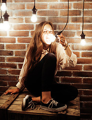 Image showing pretty teenage girl having fun in stylish modern loft studio, lifestyle people concept 