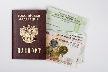 Image showing Passport, insurance certificate and money on a white background