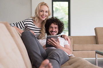 Image showing couple relaxing at  home with tablet computers