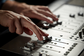 Image showing hands on mixing console in music recording studio