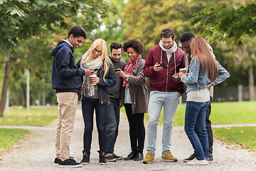 Image showing happy friends with smartphone and coffee outdoors