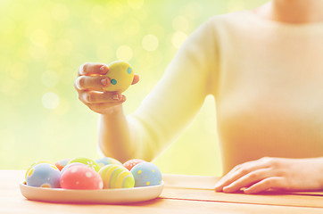 Image showing close up of woman hands with colored easter eggs