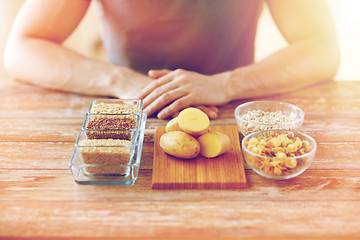 Image showing close up of male hands with carbohydrate food