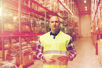 Image showing manual worker with tablet pc at warehouse