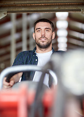 Image showing man or farmer driving tractor at farm