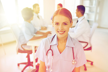 Image showing happy doctor over group of medics at hospital