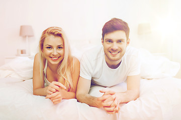 Image showing happy couple lying in bed at home