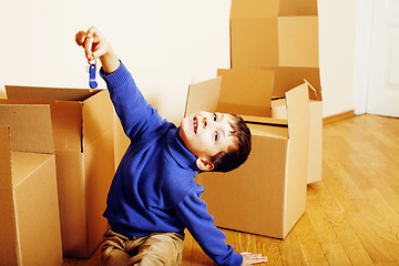 Image showing little cute boy in empty room, remoove to new house. home alone, lifestyle people concept