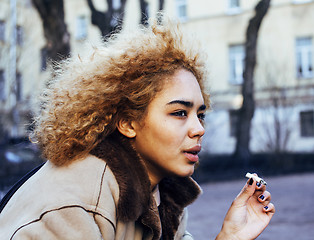 Image showing young pretty girl teenage outside smoking cigarette close up, lo