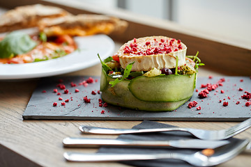 Image showing goat cheese salad with vegetables at restaurant