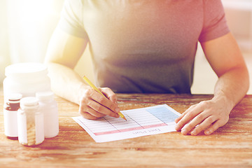 Image showing close up of man with protein jars and diet plan