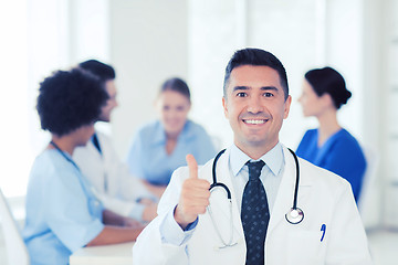 Image showing happy doctor over group of medics at hospital