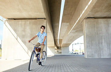 Image showing young hipster man riding fixed gear bike