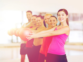 Image showing group of smiling people working out with ball