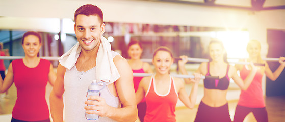 Image showing smiling trainer in front of group of people