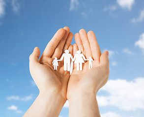 Image showing close up of hands holding paper family pictogram