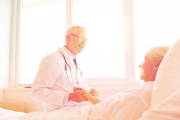 Image showing doctor checking senior woman pulse at hospital