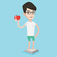 Image showing Man standing on scale and holding apple in hand.