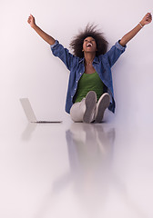 Image showing african american woman sitting on floor with laptop