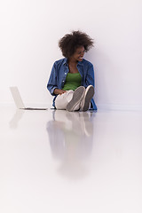 Image showing african american woman sitting on floor with laptop