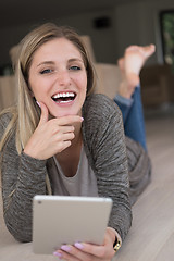 Image showing young women used tablet computer on the floor