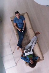 Image showing young multiethnic couple relaxes in the living room top view