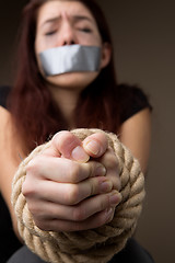 Image showing Unhappy brunette with hands tied