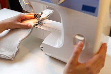 Image showing Photo of girl with sewing-machine