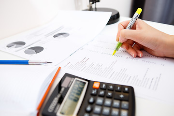 Image showing Girl prepares accounts at table