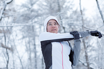 Image showing Winter girl on stretching exercises