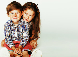 Image showing little cute boy and girl hugging playing on white background, ha