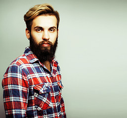 Image showing portrait of young bearded hipster guy smiling on white backgroun