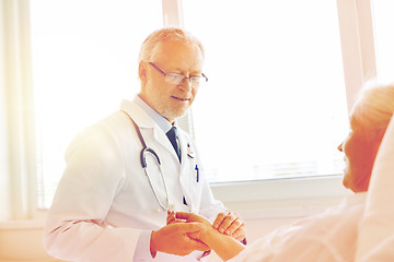 Image showing doctor checking senior woman pulse at hospital