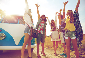 Image showing smiling hippie friends having fun over minivan car