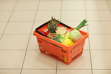 Image showing food basket on grocery or supermarket floor