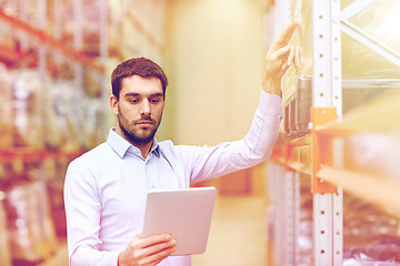 Image showing businessman with tablet pc at warehouse