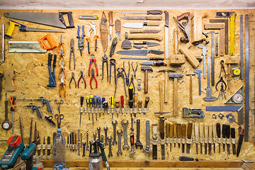 Image showing work tools hanging on wall at workshop