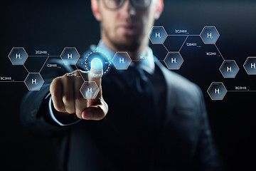 Image showing close up of scientist and virtual chemical formula