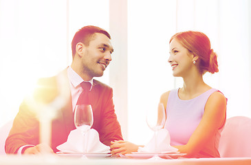 Image showing smiling couple looking at each other at restaurant