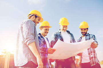 Image showing group of builders with tablet pc and blueprint