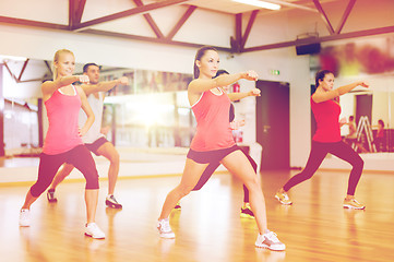 Image showing group of smiling people exercising in the gym