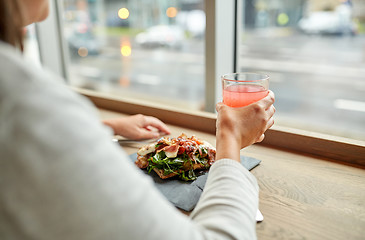 Image showing woman with salad and glass of drink at restaurant