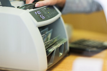 Image showing dollars in electronic money counter at bank office