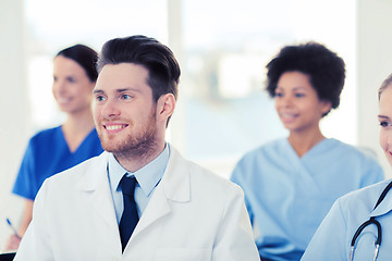 Image showing happy doctor over group of medics at hospital