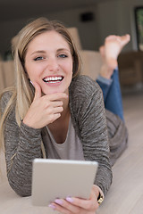 Image showing young women used tablet computer on the floor