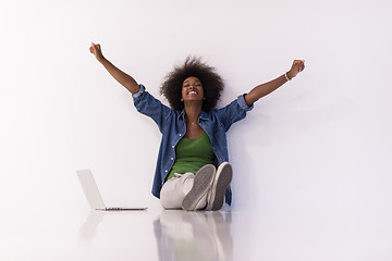 Image showing african american woman sitting on floor with laptop