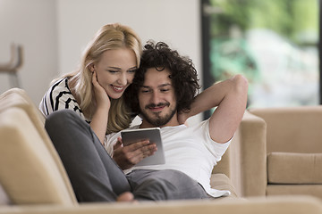 Image showing couple relaxing at  home with tablet computers