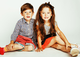 Image showing little cute boy and girl hugging playing on white background, ha