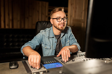 Image showing man at mixing console in music recording studio